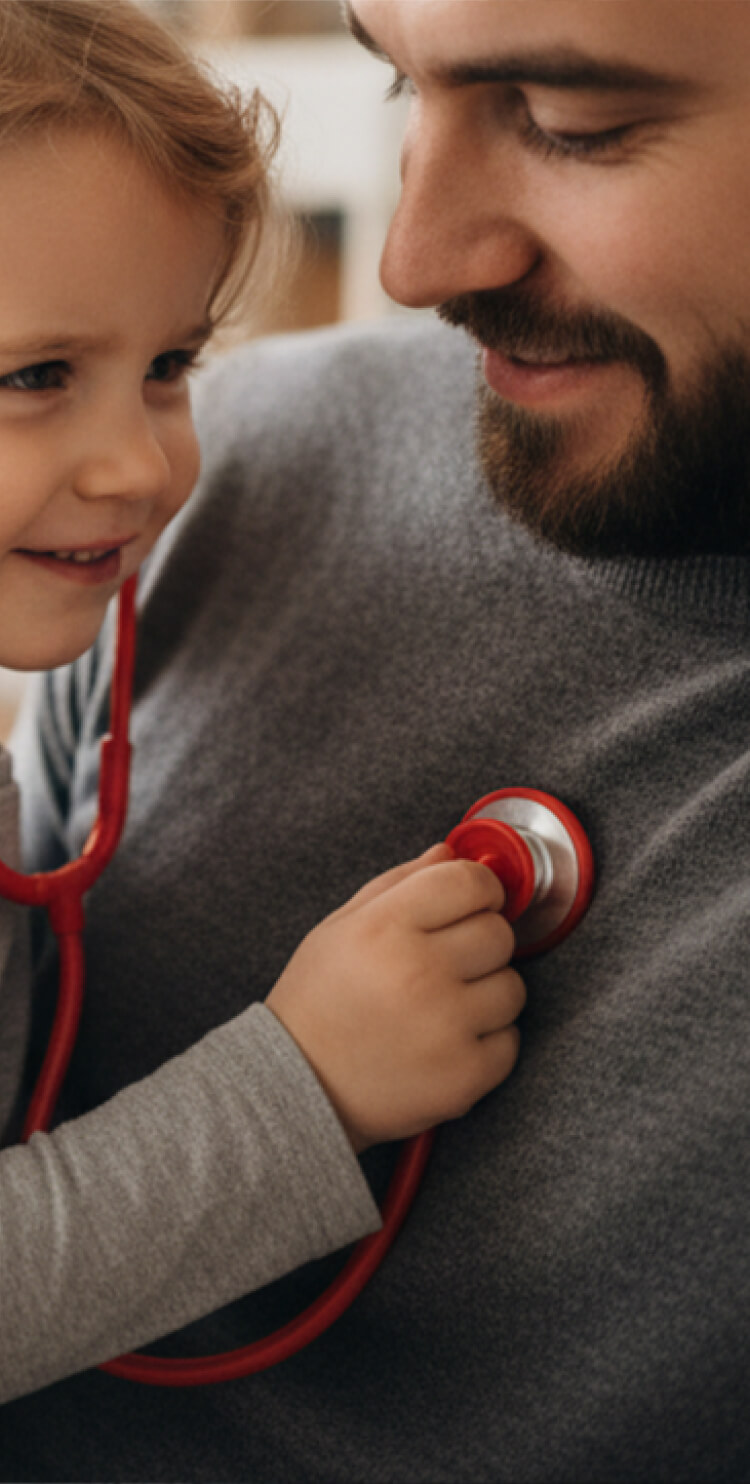 Photo of child with stethoscope on father’s chest